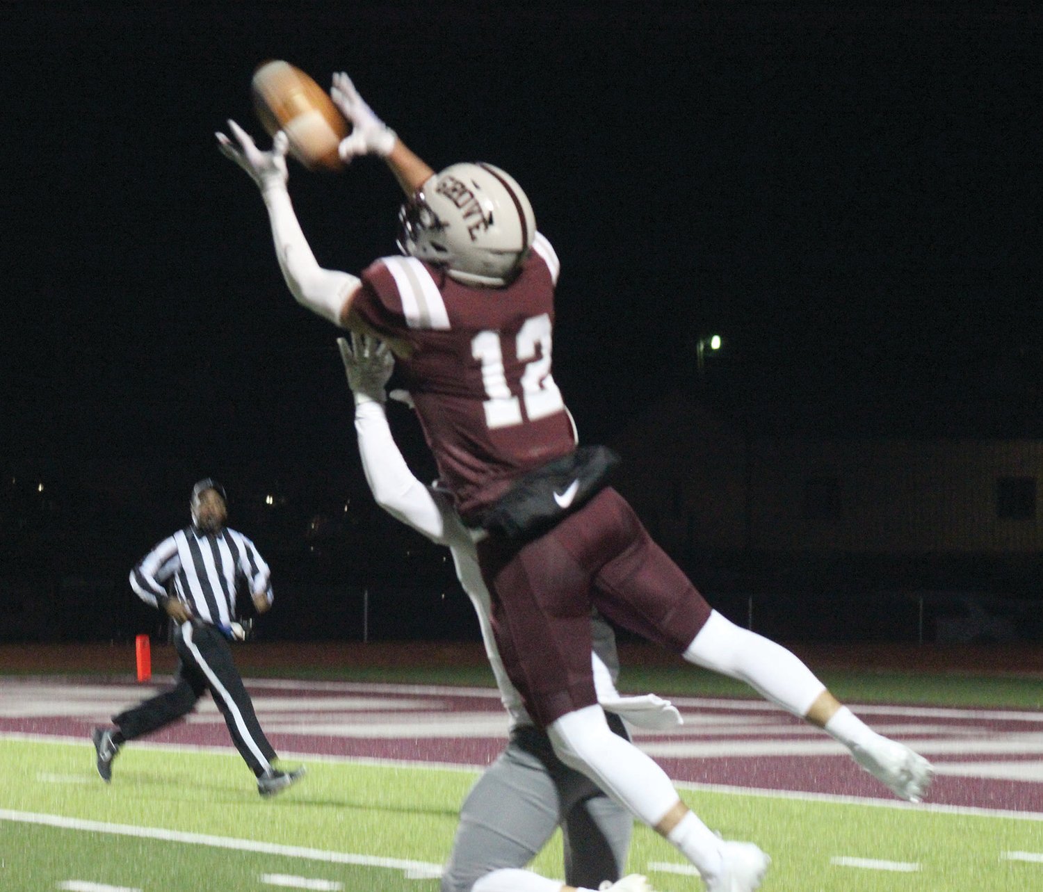 Mountain Grove’s Jace Dowden goes up and over a Reeds Spring defender on a fourth down pass to make a catch and eventually scores a touchdown.